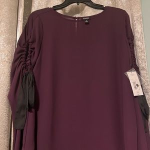 Ana brand. Very good quality. Crutches peek a boo on the sleeves.